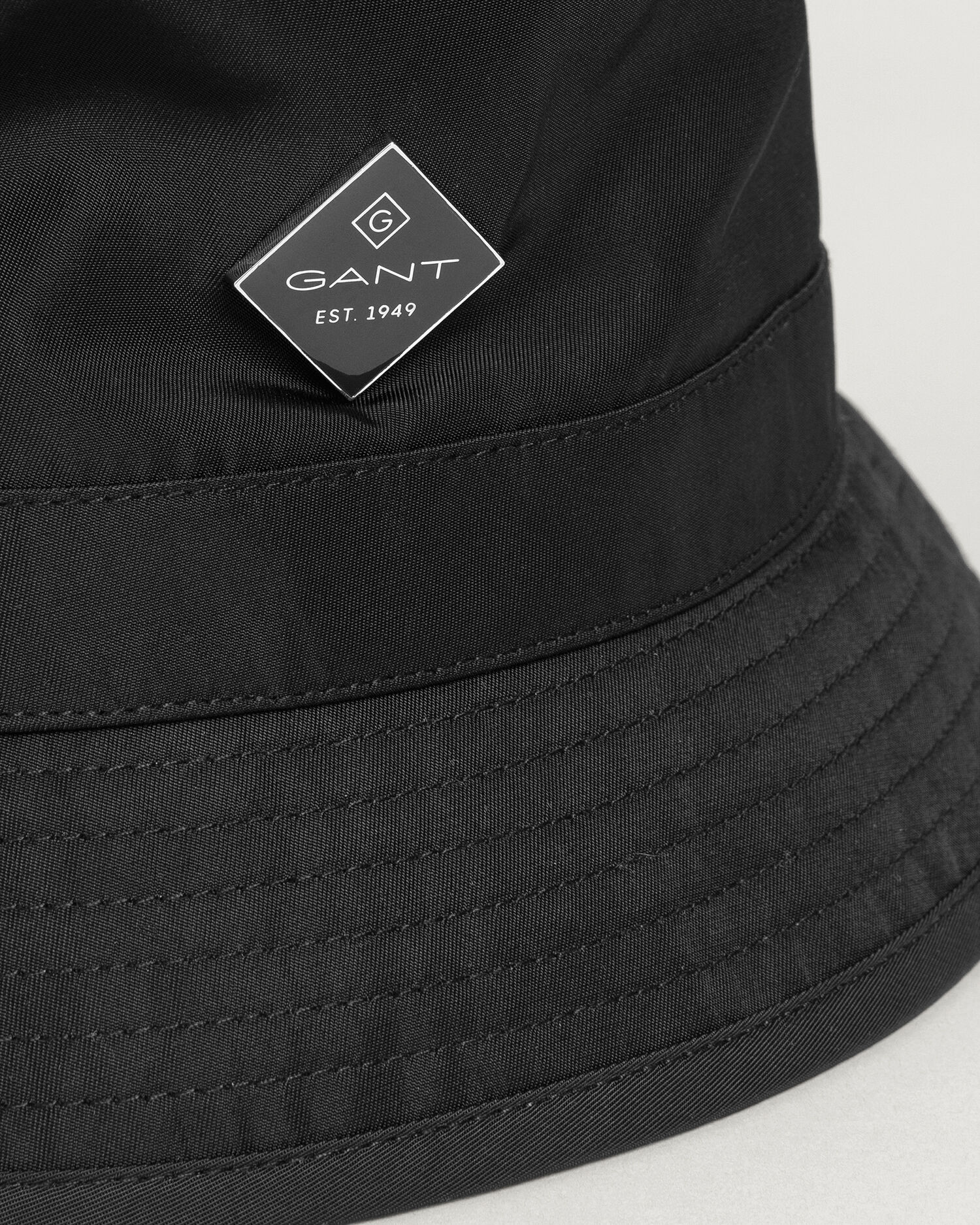 black shiny bucket hat